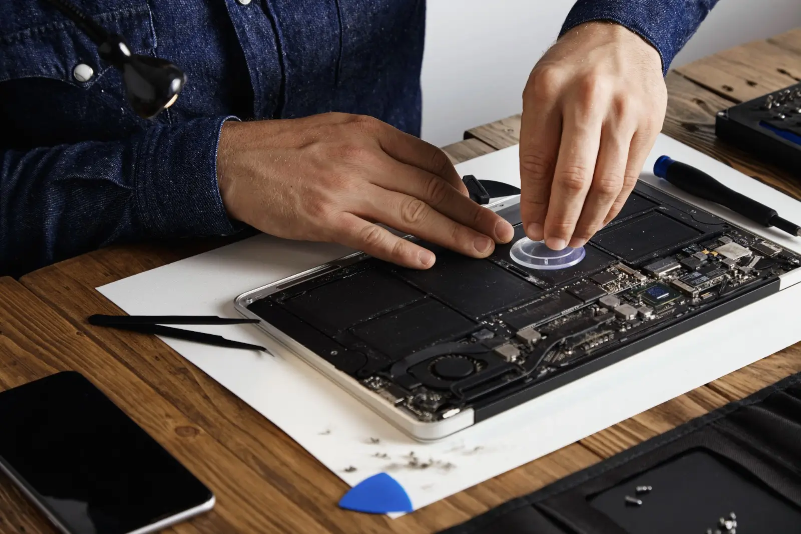Team repairing a MacBook in Dubai